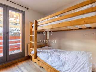 Discover a cozy bedroom featuring a charming wooden bunk bed, perfect for accommodating guests.