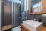 Discover a modern bathroom design featuring a sleek shower and a stylish sink.