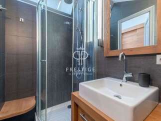 Discover a modern bathroom design featuring a sleek shower and a stylish sink.