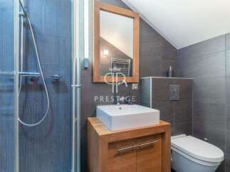 This modern bathroom features a sleek design with a walk-in shower and a stylish vanity.