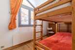 Discover a cozy bedroom featuring a charming bunk bed, perfect for accommodating guests or family.