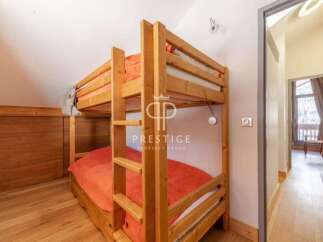 Discover a cozy bedroom featuring a charming wooden bunk bed, perfect for accommodating guests or family.