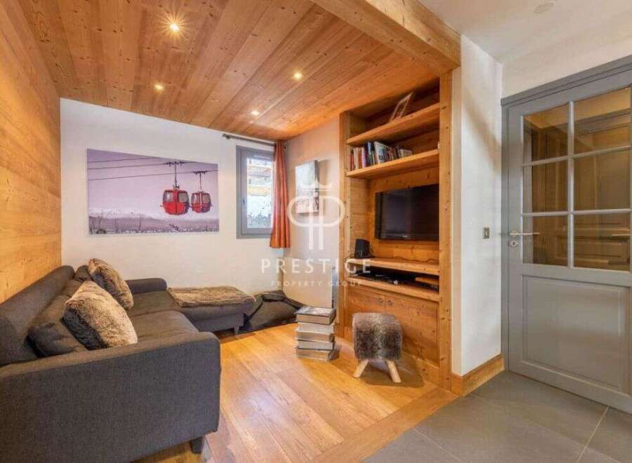 Discover the charm of this cozy living space, featuring a stylish sofa and a built-in entertainment center.