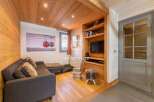 Discover the charm of this cozy living space, featuring a stylish sofa and a built-in entertainment center.