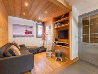 Discover the charm of this cozy living space, featuring a stylish sofa and a built-in entertainment center.