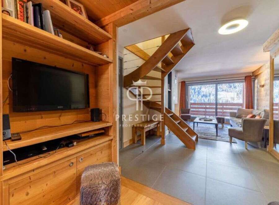 Discover the charm of this stunning property, featuring a cozy living space with a modern TV setup.