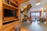 Discover the charm of this stunning property, featuring a cozy living space with a modern TV setup.
