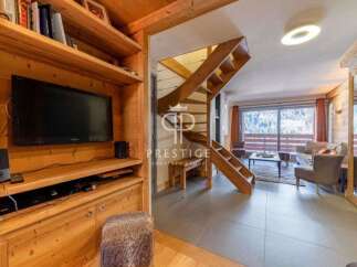 Discover the charm of this stunning property, featuring a cozy living space with a modern TV setup.