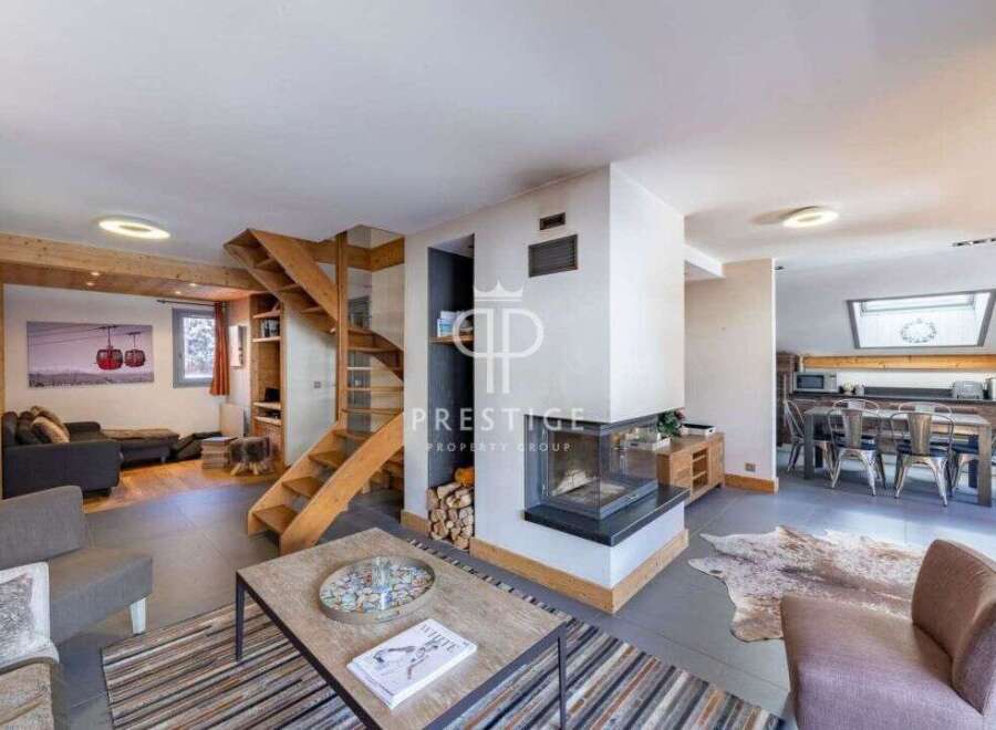Discover luxury living in this stunning property, featuring a modern fireplace and a stylish staircase.