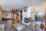 Discover luxury living in this stunning property, featuring a modern fireplace and a stylish staircase.