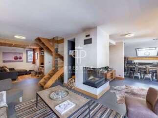 Discover luxury living in this stunning property, featuring a modern fireplace and a stylish staircase.