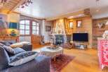 Experience the charm of this cozy living room, featuring a rustic fireplace and wooden accents.
