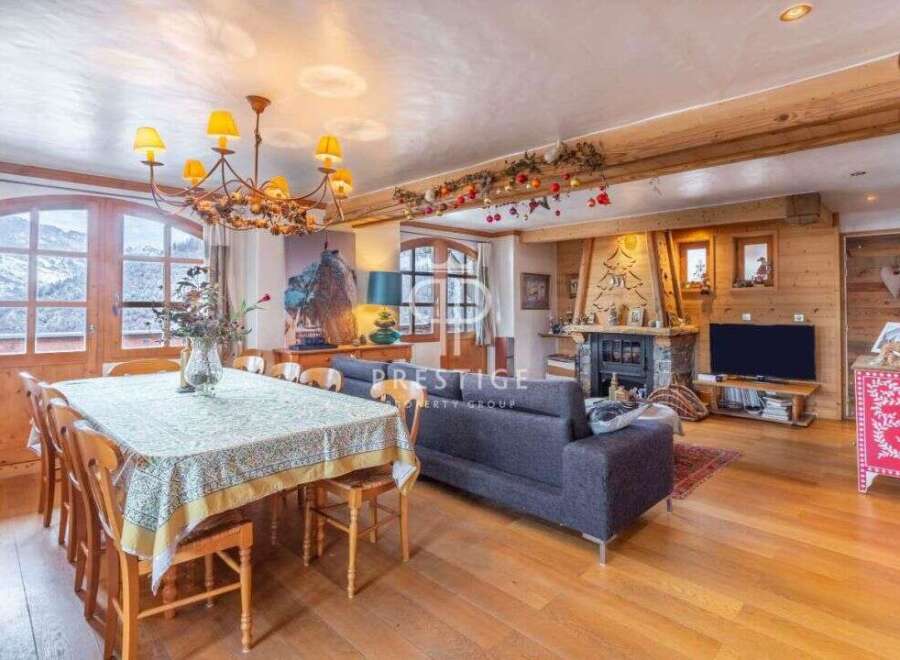 Experience luxury living in this stunning property, featuring a cozy fireplace and a spacious dining area perfect for entertaining.