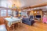 Experience luxury living in this stunning property, featuring a cozy fireplace and a spacious dining area perfect for entertaining.