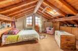 Discover the charm of this cozy bedroom with its rustic wooden beams and inviting atmosphere.