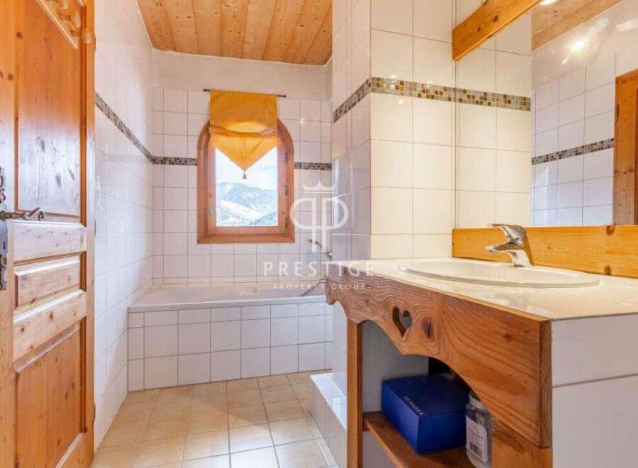 Discover the charm of this bathroom, featuring a wooden vanity and a cozy ambiance.