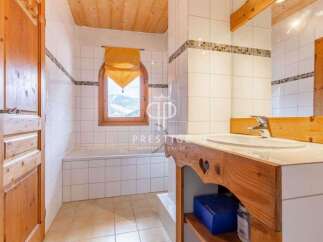 Discover the charm of this bathroom, featuring a wooden vanity and a cozy ambiance.