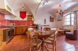 Discover the charm of this unique property, featuring a cozy dining area with a round wooden table and chairs.