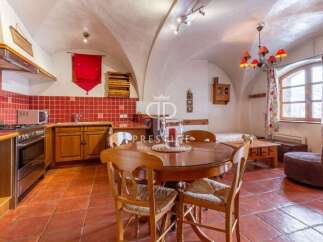 Discover the charm of this unique property, featuring a cozy dining area with a round wooden table and chairs.