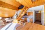 Discover a cozy and inviting living space with a unique wooden design.