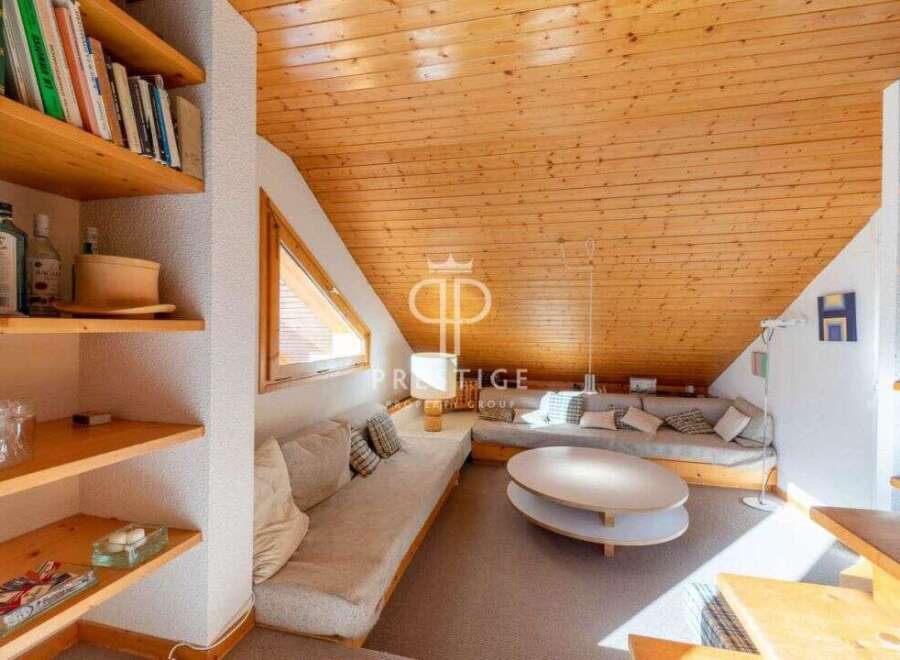 Discover the charm of this unique property with its cozy, wood-paneled ceiling and inviting living space.
