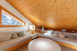 Discover the charm of this cozy property, featuring a unique sloped ceiling and warm wooden accents.