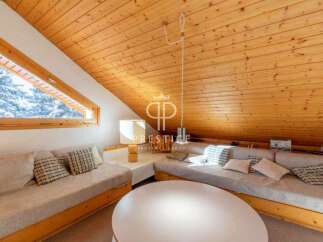Discover the charm of this cozy property, featuring a unique sloped ceiling and warm wooden accents.