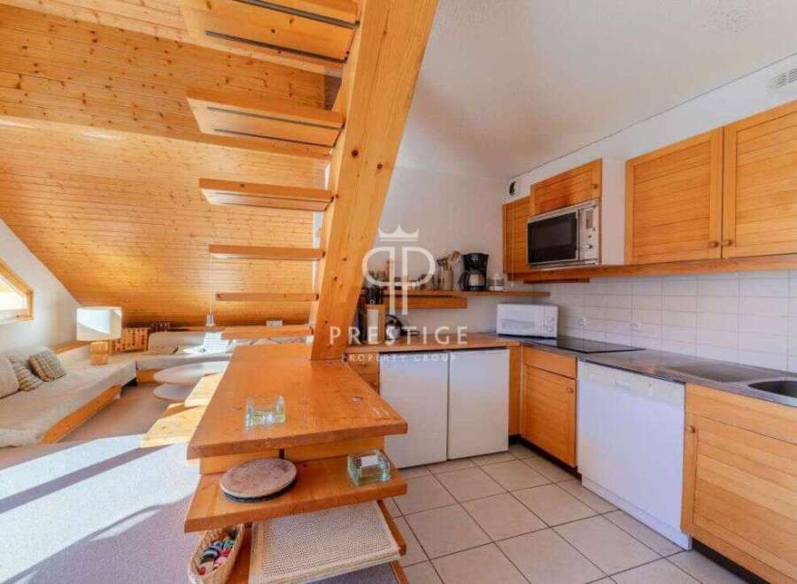Discover a charming property featuring a unique wooden staircase and a cozy living area.