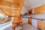 Discover a charming property featuring a unique wooden staircase and a cozy living area.