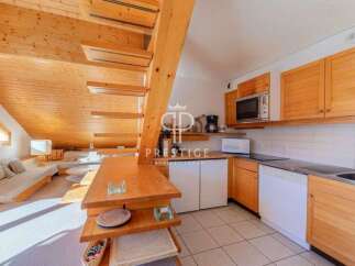 Discover a charming property featuring a unique wooden staircase and a cozy living area.