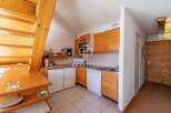 Discover a charming kitchen with wooden cabinets and a cozy dining area.