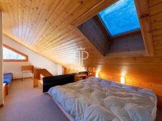 Discover a cozy retreat with this charming bedroom featuring a unique wooden ceiling and a skylight that floods the space with natural light.
