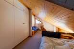 Discover a unique property with a charming, sloped wooden ceiling that adds character and warmth.