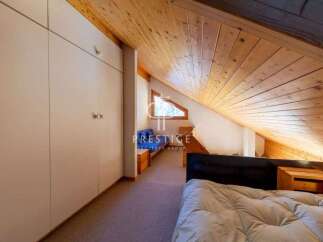 Discover a unique property with a charming, sloped wooden ceiling that adds character and warmth.