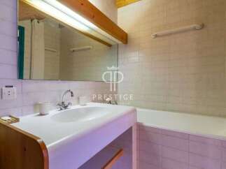 Discover a charming bathroom featuring a sleek sink and a relaxing bathtub.