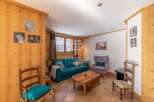 Cozy living room with wooden accents and a comfortable teal sofa.