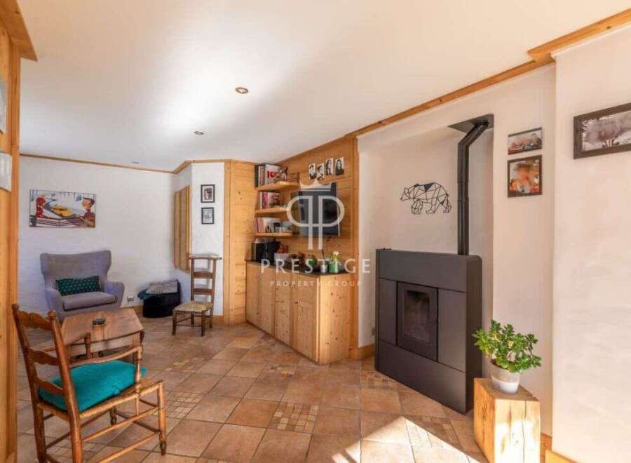 Discover the charm of this cozy living space, featuring a stylish fireplace and built-in wooden shelving.