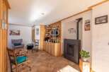 Discover the charm of this cozy living space, featuring a stylish fireplace and built-in wooden shelving.