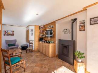 Discover the charm of this cozy living space, featuring a stylish fireplace and built-in wooden shelving.