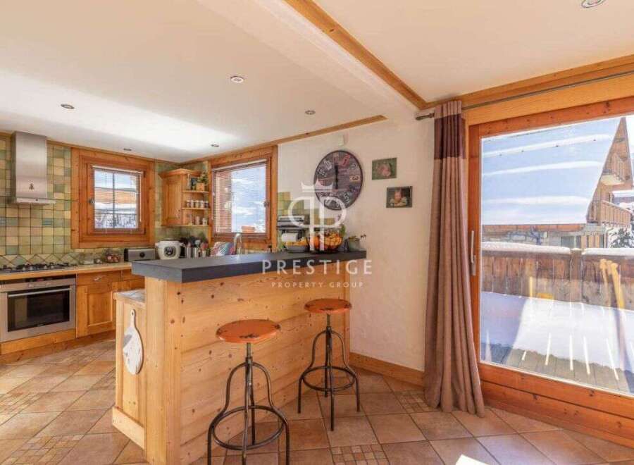Discover the charm of this cozy kitchen, featuring rustic wooden cabinetry and a stylish breakfast bar.