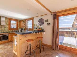 Discover the charm of this cozy kitchen, featuring rustic wooden cabinetry and a stylish breakfast bar.