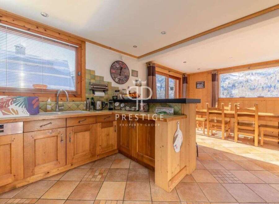 Discover the charm of this property, featuring a cozy kitchen with wooden cabinetry and a breakfast bar.