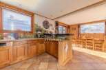 Discover the charm of this property, featuring a cozy kitchen with wooden cabinetry and a breakfast bar.