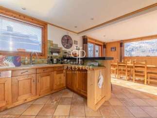Discover the charm of this property, featuring a cozy kitchen with wooden cabinetry and a breakfast bar.