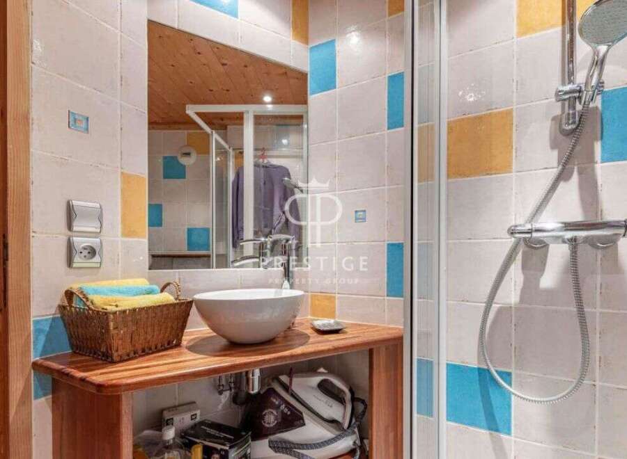 Discover a stylish bathroom featuring a modern sink and a refreshing shower.