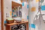 Discover a stylish bathroom featuring a modern sink and a refreshing shower.