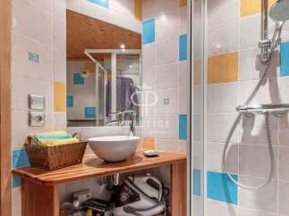 Discover a stylish bathroom featuring a modern sink and a refreshing shower.