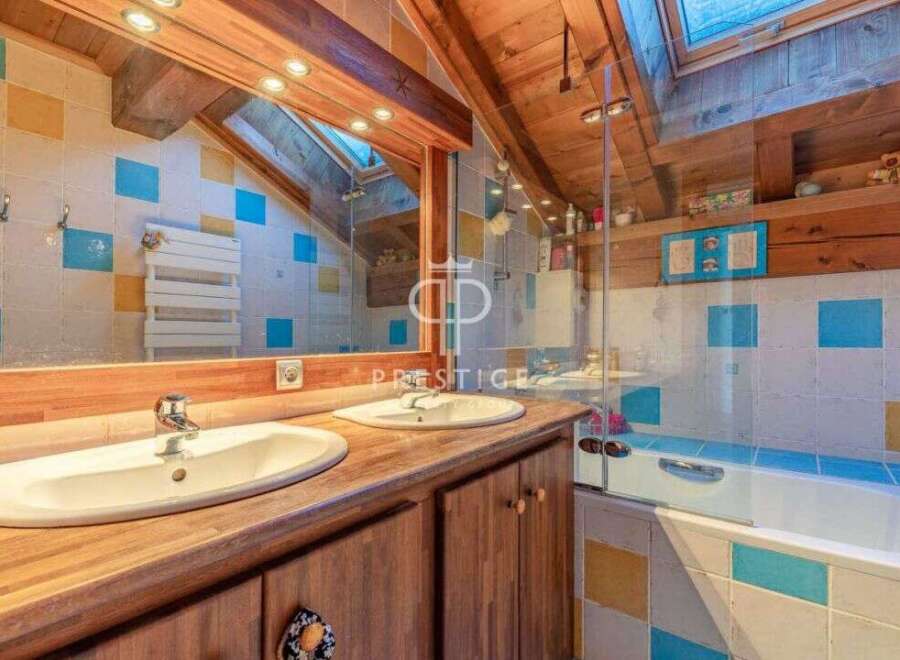 Discover the charm of this unique property, featuring a beautifully designed bathroom with a rustic wooden aesthetic.