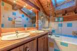 Discover the charm of this unique property, featuring a beautifully designed bathroom with a rustic wooden aesthetic.