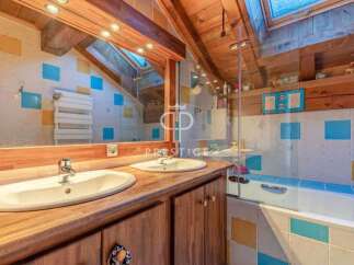 Discover the charm of this unique property, featuring a beautifully designed bathroom with a rustic wooden aesthetic.